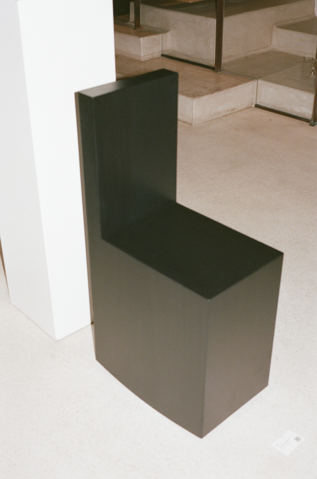 Art Rocker by Studio Goons in black satin on a pale floor at OGATA Paris.