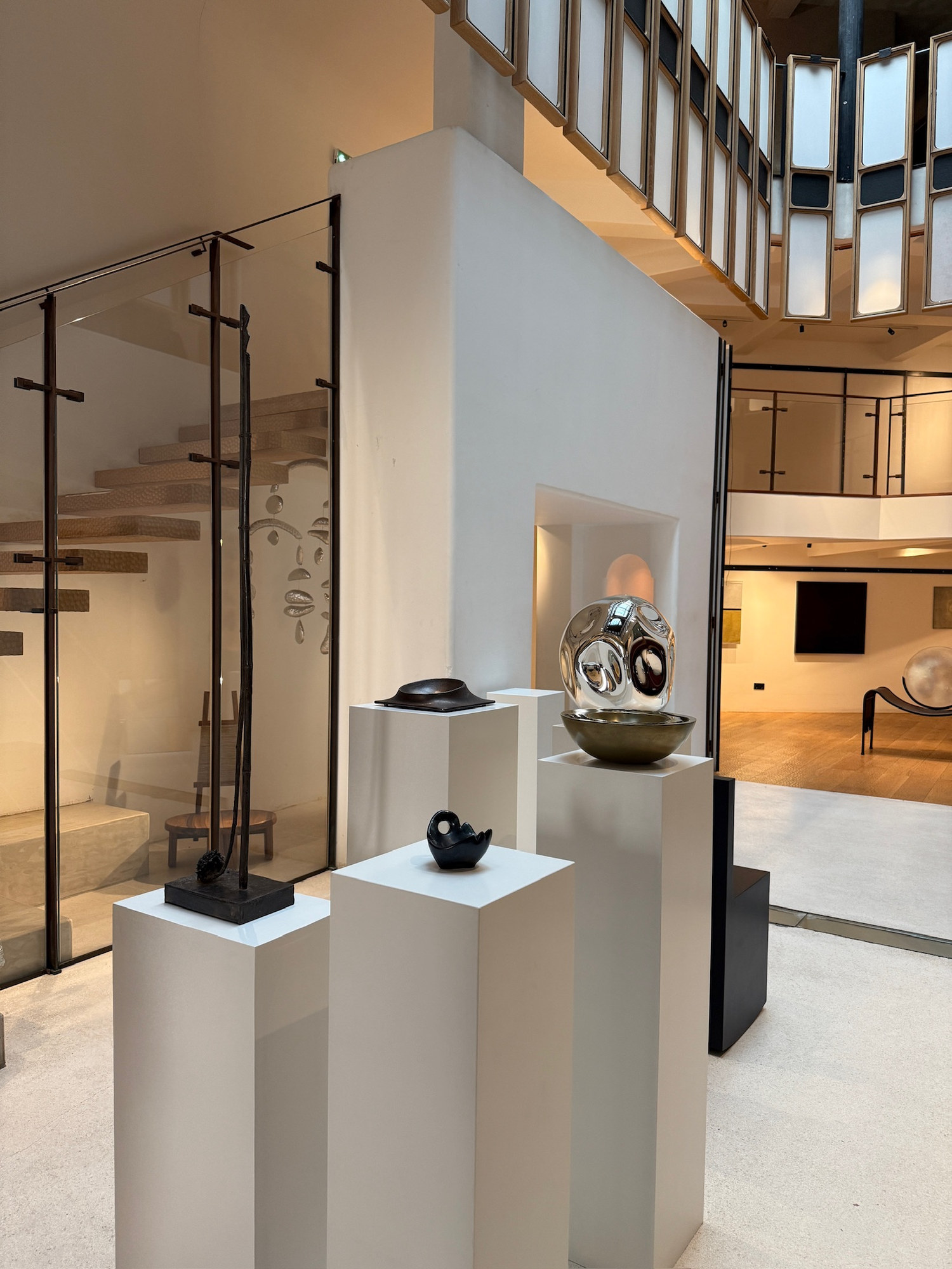 Art Rocker by Studio Goons beside white plinths with objects, at OGATA Paris.