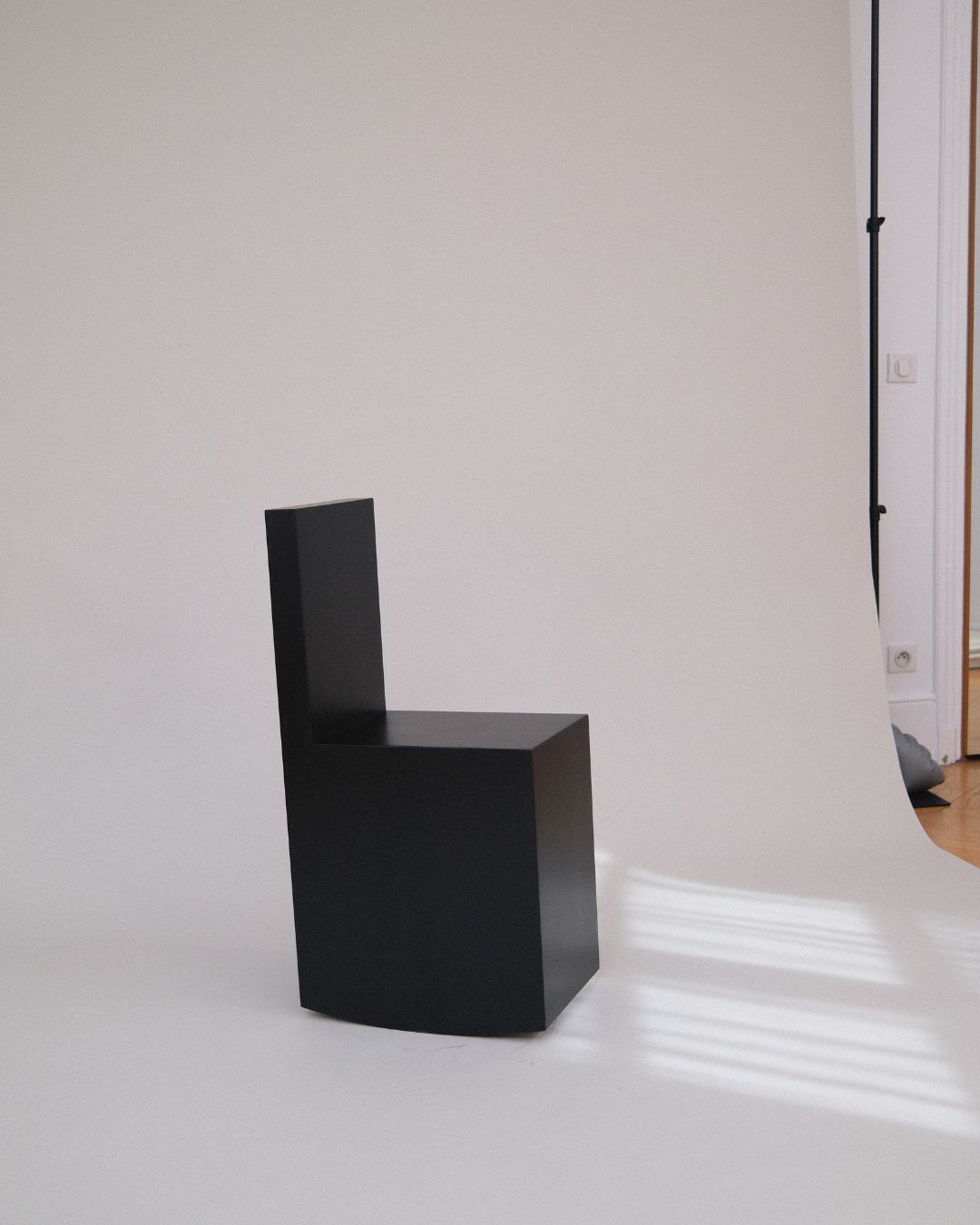 Art Rocker by Studio Goons in black satin on a white studio backdrop