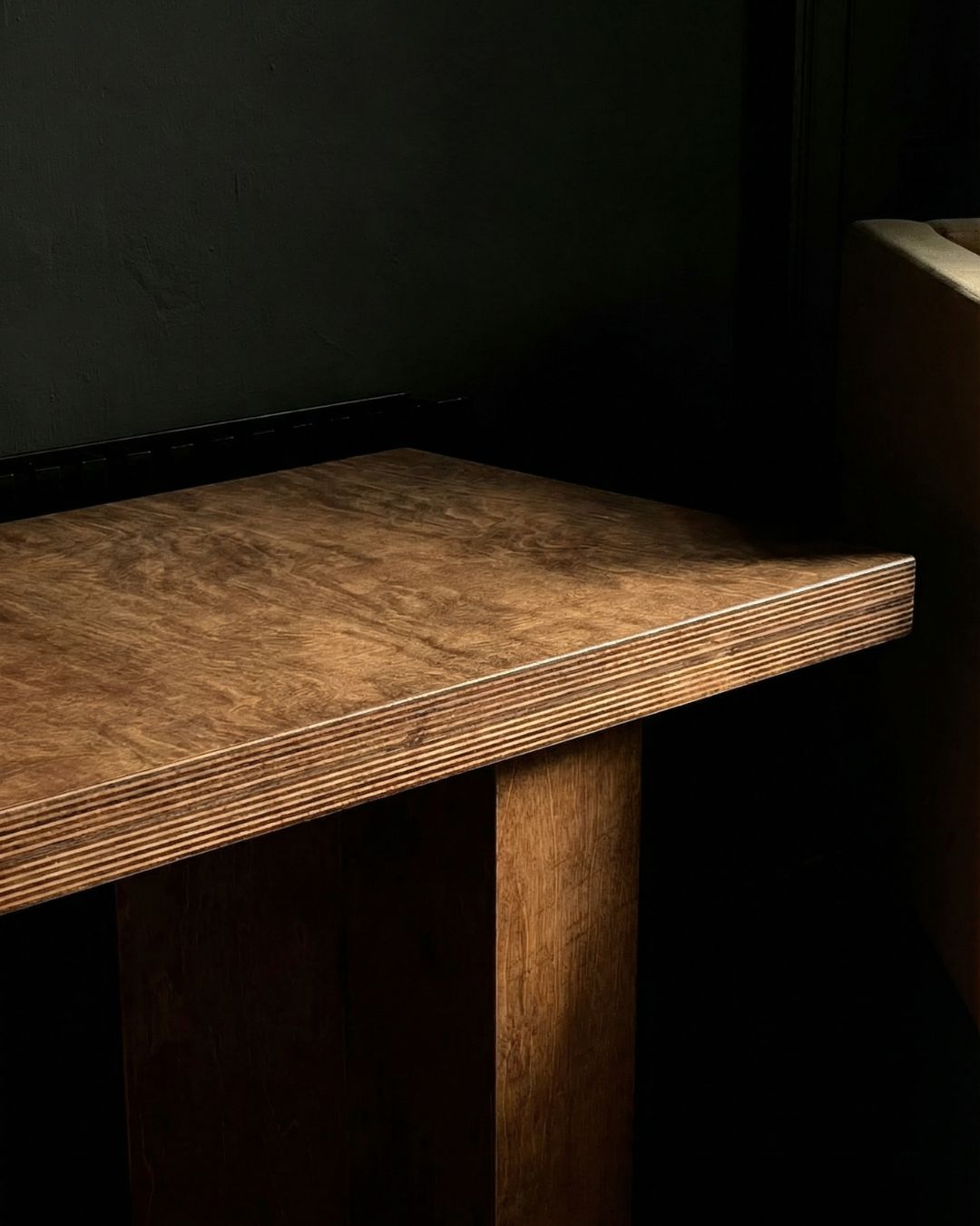 Close view of the oak seat and leg of the Double Bench by Studio Goons