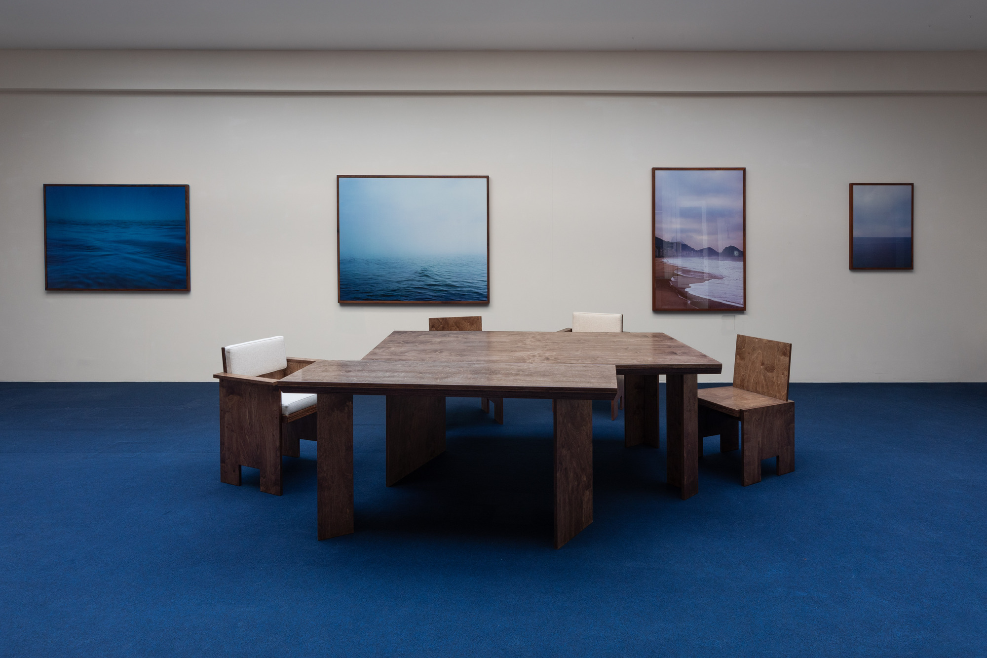Brace Chairs AC (dining chair with Armrests and Cushions) and Brace chairs (without arms and cushions) with the Five Points Table Large and Five Points console