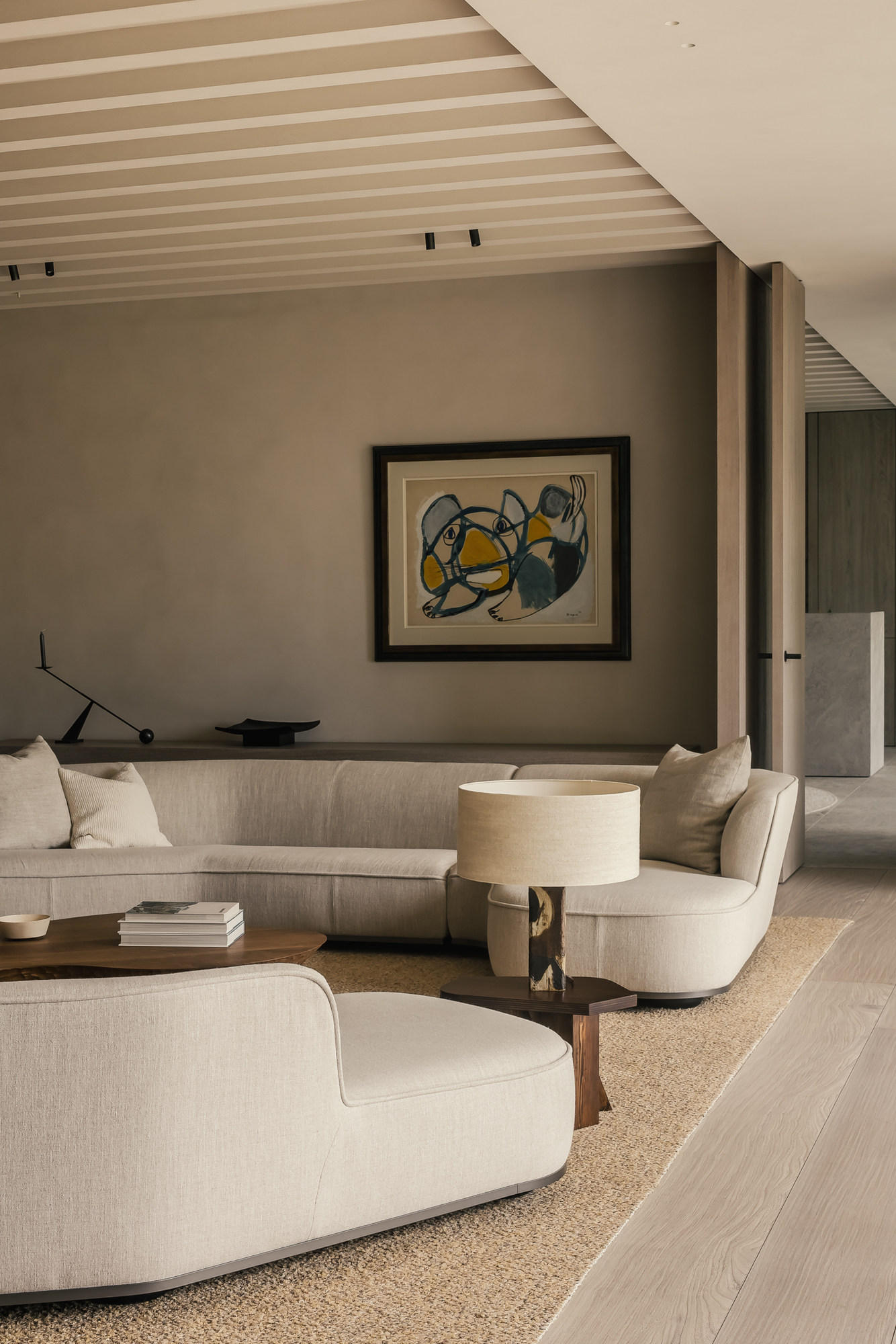 Living room with a curved sofa and the Original Stool by Studio Goons used as a lamp table, VC House by Simon de Burbure, Knokke, photograph by Cafeine.
